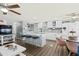 Modern and open living space with a kitchen featuring seating and stainless steel appliances and a connected dining area at 10243 E Illini St, Mesa, AZ 85208