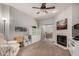 Inviting living room features a fireplace, ceiling fan, and sliding glass doors to the balcony at 10410 N Cave Creek Rd # 1078, Phoenix, AZ 85020