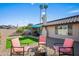 Relaxing backyard with a fire pit, comfortable seating, and well-maintained landscaping at 11604 S Ki Rd, Phoenix, AZ 85044