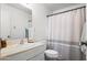 Bright bathroom featuring a vanity with mirror and shower/tub combination with striped shower curtain at 11604 S Ki Rd, Phoenix, AZ 85044