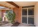 Welcoming front entrance with decorative security doors, brick accents, and manicured landscaping at 11604 S Ki Rd, Phoenix, AZ 85044