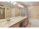 Neutral bathroom boasts a double sink vanity, tub/shower combo with patterned shower curtain, and decorative ladder detail at 13828 S 42Nd St, Phoenix, AZ 85044