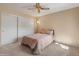 Cozy bedroom features neutral carpet, closet with sliding doors, a ceiling fan and soothing wall colors, and simple furnishings at 13828 S 42Nd St, Phoenix, AZ 85044