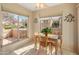 Bright dining area is enhanced by large windows offering views of the outside, and a wooden table with four chairs at 13828 S 42Nd St, Phoenix, AZ 85044