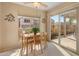 Light-filled dining area features views through the sliding glass door to the patio, plus a large window to the neighborhood at 13828 S 42Nd St, Phoenix, AZ 85044