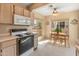 Bright kitchen features an oven, microwave, and a dining table near the large windows that offer views of the neighborhood at 13828 S 42Nd St, Phoenix, AZ 85044