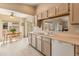 Sunlit eat-in kitchen with sliding glass doors, neutral counters, and abundant cabinets at 13828 S 42Nd St, Phoenix, AZ 85044