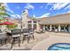 Outdoor living space featuring bar seating, lounge chairs, and a sparkling pool with a lush desert landscape at 14244 N 14Th Pl, Phoenix, AZ 85022