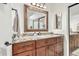 Bathroom vanity with granite countertop, wood cabinets, and decorative mirror at 14244 N 14Th Pl, Phoenix, AZ 85022