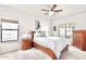 Bright bedroom featuring a ceiling fan, carpeted floors, and wood furnishings at 14244 N 14Th Pl, Phoenix, AZ 85022