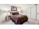 Neutral-toned bedroom with decorative lamps, carpet, and ensuite bathroom at 14244 N 14Th Pl, Phoenix, AZ 85022