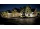 Elegant home exterior illuminated at night, showcasing landscaping and architectural details at 14244 N 14Th Pl, Phoenix, AZ 85022