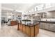 Spacious kitchen featuring a large island, black countertops, and stainless steel appliances at 14244 N 14Th Pl, Phoenix, AZ 85022