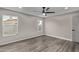 Clean and bright bedroom with neutral walls, wood plank flooring and a ceiling fan at 15868 N 18Th N Pl, Phoenix, AZ 85022