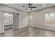 Spacious bedroom with two windows and a sliding barn door to the bathroom at 15868 N 18Th N Pl, Phoenix, AZ 85022