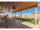 Covered patio with ceiling fans, outdoor kitchen and grill, and a view of the backyard at 1614 W Beaubien Dr, Phoenix, AZ 85027