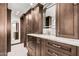 Bathroom featuring custom cabinetry with marble countertops, unique mirror and tiled flooring at 1614 W Beaubien Dr, Phoenix, AZ 85027