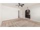 Cozy bedroom featuring a ceiling fan and entryway with dark-stained cabinets at 1614 W Beaubien Dr, Phoenix, AZ 85027