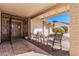 Covered front porch with brick accents, seating area, providing a cozy outdoor space at 1614 W Beaubien Dr, Phoenix, AZ 85027