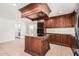 Well-equipped kitchen featuring a center island with cooktop and custom cabinetry at 1614 W Beaubien Dr, Phoenix, AZ 85027