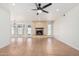 Spacious living room with a fireplace, tile flooring, and ample natural light from large windows at 1614 W Beaubien Dr, Phoenix, AZ 85027