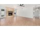 Bright living room featuring tile floors, a cozy fireplace, and a modern ceiling fan at 1614 W Beaubien Dr, Phoenix, AZ 85027