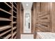 Spacious walk-in closet with custom wood shelving and granite countertops at 1614 W Beaubien Dr, Phoenix, AZ 85027