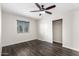 Cozy bedroom with wood-look floors, a ceiling fan, and ample closet space, perfect for relaxation at 17408 N 14Th Ave, Phoenix, AZ 85023