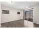 Bright bedroom with wood-look floors, two windows, and a sliding glass door leading to the patio at 17408 N 14Th Ave, Phoenix, AZ 85023