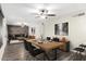 Stylish dining room showcasing a wooden table set for six, with an open floor plan leading to a comfortable living area at 17408 N 14Th Ave, Phoenix, AZ 85023