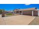 Exterior view showcasing the home's stone facade, well-maintained lawn, and spacious driveway at 17408 N 14Th Ave, Phoenix, AZ 85023