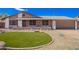 Charming stone-accented home with a manicured lawn and a two-car garage, nestled under a clear blue sky at 17408 N 14Th Ave, Phoenix, AZ 85023