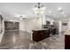 Open-concept kitchen with stainless steel appliances, granite countertops, and tile backsplash, flowing into the living space at 17408 N 14Th Ave, Phoenix, AZ 85023