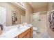 Well-lit bathroom featuring a vanity with sink and a shower with sliding glass doors at 1951 N 64Th St # 26, Mesa, AZ 85205