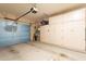 Spacious garage with built-in cabinets and a blue sectional garage door at 1951 N 64Th St # 26, Mesa, AZ 85205