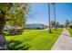 Lush green community featuring gazebo, walkway, and mature trees creating a serene environment at 1951 N 64Th St # 26, Mesa, AZ 85205