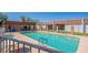 Sparkling community pool and spa surrounded by sun-soaked deck, lounge chairs, and covered cabana at 1951 N 64Th St # 26, Mesa, AZ 85205