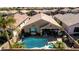 Aerial view of the backyard with pool, patio, and desert landscaping at 202 W Twin Peaks Pkwy, San Tan Valley, AZ 85143