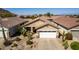 Home with tile roof, two-car garage, and desert landscaping in a neat community at 202 W Twin Peaks Pkwy, San Tan Valley, AZ 85143