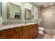 Well-lit bathroom with double sinks, a walk-in shower, and tiled floors at 202 W Twin Peaks Pkwy, San Tan Valley, AZ 85143