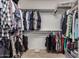 This is a walk-in closet with ample hanging space and storage shelves at 202 W Twin Peaks Pkwy, San Tan Valley, AZ 85143