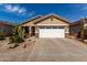 Charming home featuring a two-car garage, desert landscaping, and a warm, inviting facade at 202 W Twin Peaks Pkwy, San Tan Valley, AZ 85143