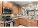 Kitchen with stainless steel appliances, granite countertops, and a pass-through window to another room at 202 W Twin Peaks Pkwy, San Tan Valley, AZ 85143