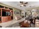 Spacious living room with hardwood entertainment center, comfortable furniture, and a view of the kitchen at 202 W Twin Peaks Pkwy, San Tan Valley, AZ 85143