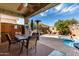 Covered patio with dining table, built-in barbecue, and pool at 202 W Twin Peaks Pkwy, San Tan Valley, AZ 85143