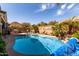 Backyard pool and outdoor kitchen area with a mountain view at 202 W Twin Peaks Pkwy, San Tan Valley, AZ 85143