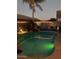 Night view of backyard pool with decorative lighting and palm trees at 202 W Twin Peaks Pkwy, San Tan Valley, AZ 85143