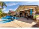 Backyard patio with pool, spa, and dining area at 202 W Twin Peaks Pkwy, San Tan Valley, AZ 85143