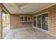 Covered patio with brick columns, concrete floors, ceiling fan and sliding glass doors at 2110 E Laguna Dr, Tempe, AZ 85282