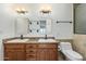 Bathroom with double sinks, granite countertop and framed mirror, plus a toilet at 2110 E Laguna Dr, Tempe, AZ 85282